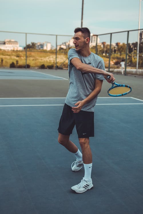 A man holding a racket on a court